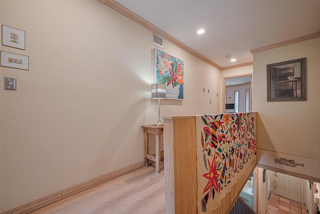 674 S Ripple Creek Dr Unit 674, Houston, TX 77057 - hall featuring ornamental molding, recessed lighting, light wood-style flooring, and a textured ceiling