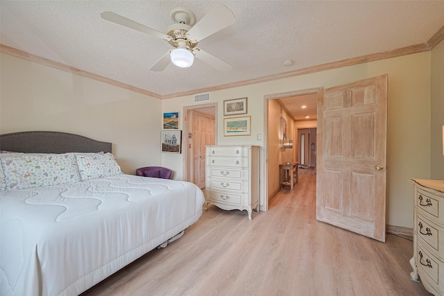 674 S Ripple Creek Dr Unit 674, Houston, TX 77057 - bedroom featuring ornamental molding, light wood-style flooring, a textured ceiling, and ceiling fan