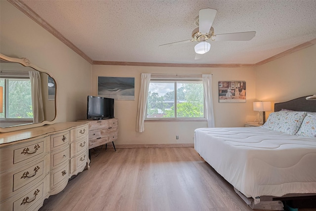 674 S Ripple Creek Dr Unit 674, Houston, TX 77057 - bedroom featuring a textured ceiling, light wood finished floors, ornamental molding, and ceiling fan