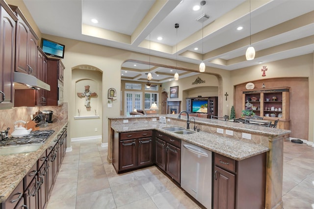 5702 Silverthorn Glen Dr, Spring, TX 77379 - kitchen with stainless steel appliances, arched walkways, open floor plan, a ceiling fan, and backsplash