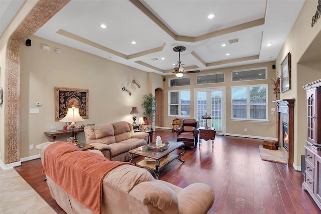 5702 Silverthorn Glen Dr, Spring, TX 77379 - living area featuring ceiling fan, arched walkways, coffered ceiling, wood finished floors, and a high end fireplace