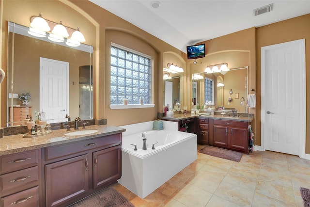 5702 Silverthorn Glen Dr, Spring, TX 77379 - bathroom featuring a garden tub, two vanities, tile patterned floors, and a shower
