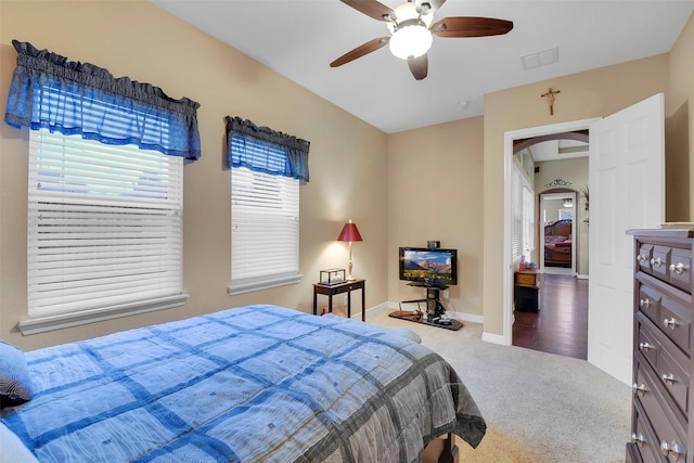 5702 Silverthorn Glen Dr, Spring, TX 77379 - bedroom with arched walkways, carpet floors, and a ceiling fan