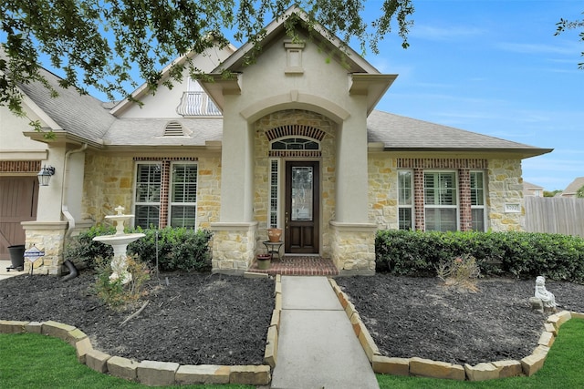 5702 Silverthorn Glen Dr, Spring, TX 77379 - property entrance featuring stone siding, a shingled roof, and stucco siding