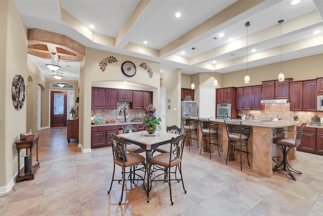 5702 Silverthorn Glen Dr, Spring, TX 77379 - dining space featuring recessed lighting, light tile patterned floors, and arched walkways