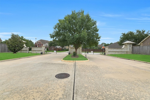 5702 Silverthorn Glen Dr, Spring, TX 77379 - view of concrete street featuring a gate, curbs, a gated entry, and a residential view