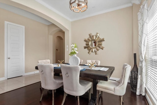 18135 Berry Garden Ln, Spring, TX 77379 - dining space with arched walkways, crown molding, a chandelier, and wood finished floors