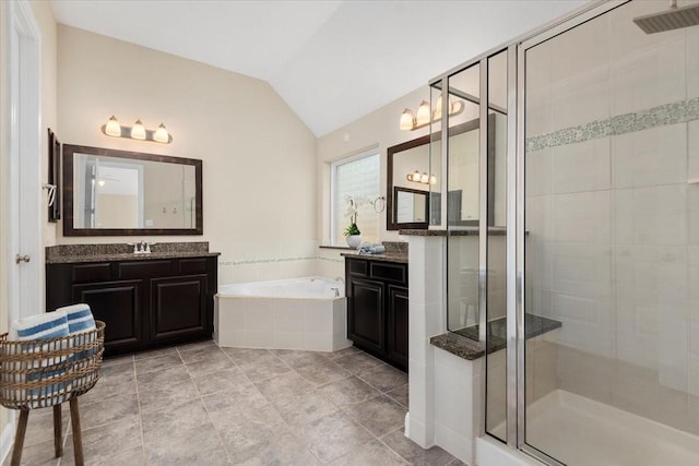18135 Berry Garden Ln, Spring, TX 77379 - bathroom featuring a shower stall, vaulted ceiling, a bath, and two vanities