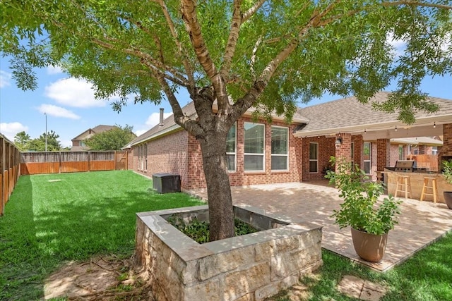 18135 Berry Garden Ln, Spring, TX 77379 - rear view of property with brick siding, a fenced backyard, a patio, and roof with shingles