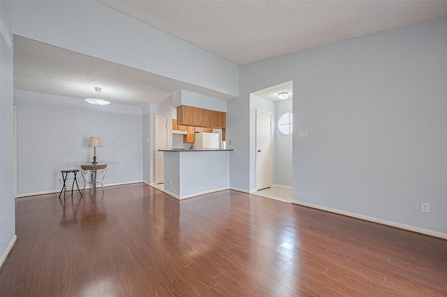 3100 Jeanetta St Unit 1104, Houston, TX 77063 - unfurnished living room with a textured ceiling and wood finished floors