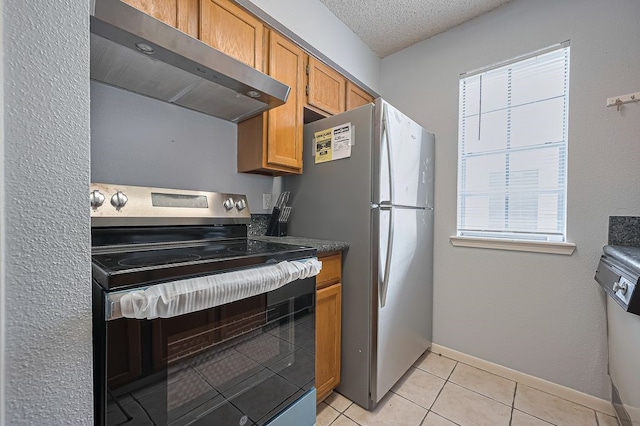 3100 Jeanetta St Unit 1104, Houston, TX 77063 - kitchen featuring stainless steel appliances, exhaust hood, light tile patterned floors, and brown cabinetry