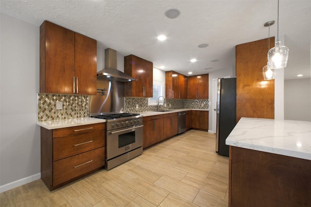 15815 Baytree Dr, Houston, TX 77070 - kitchen featuring wall chimney range hood, stainless steel appliances, backsplash, light stone countertops, and decorative light fixtures