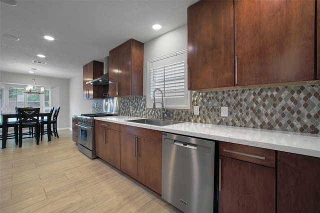 15815 Baytree Dr, Houston, TX 77070 - kitchen with appliances with stainless steel finishes, wall chimney range hood, a chandelier, backsplash, and recessed lighting