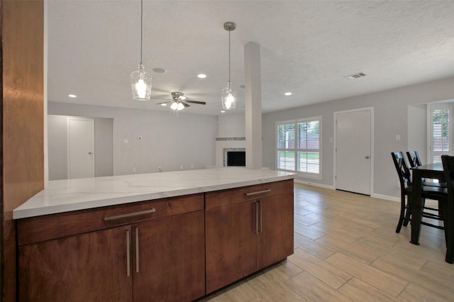 15815 Baytree Dr, Houston, TX 77070 - kitchen with a fireplace, plenty of natural light, a ceiling fan, open floor plan, and recessed lighting
