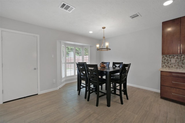 15815 Baytree Dr, Houston, TX 77070 - dining room with light wood-style flooring, a chandelier, and recessed lighting
