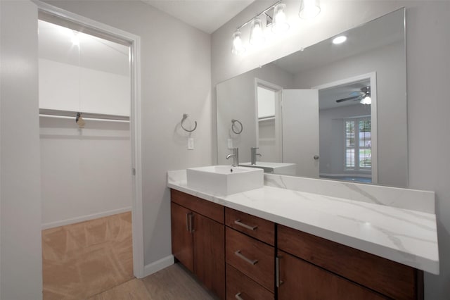 15815 Baytree Dr, Houston, TX 77070 - bathroom with vanity, ceiling fan, and a spacious closet