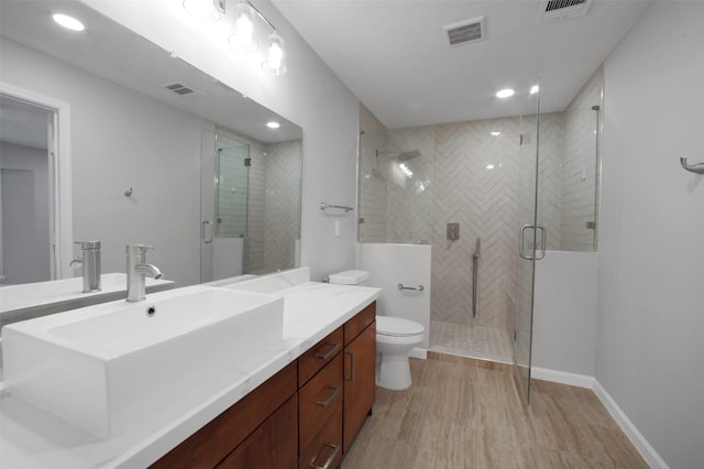 15815 Baytree Dr, Houston, TX 77070 - bathroom with vanity, a stall shower, wood finished floors, and recessed lighting