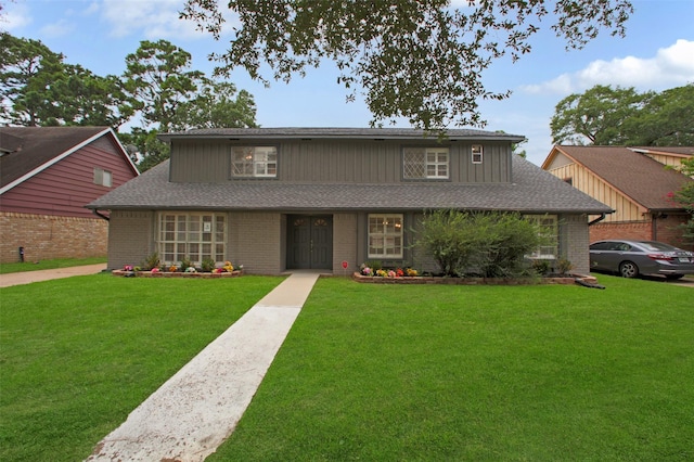 15815 Baytree Dr, Houston, TX 77070 - traditional-style house with a front yard, a shingled roof, and brick siding