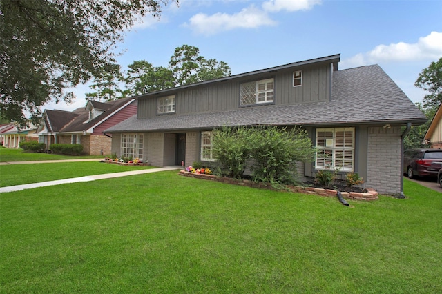 15815 Baytree Dr, Houston, TX 77070 - traditional-style house featuring a front lawn, brick siding, and a shingled roof
