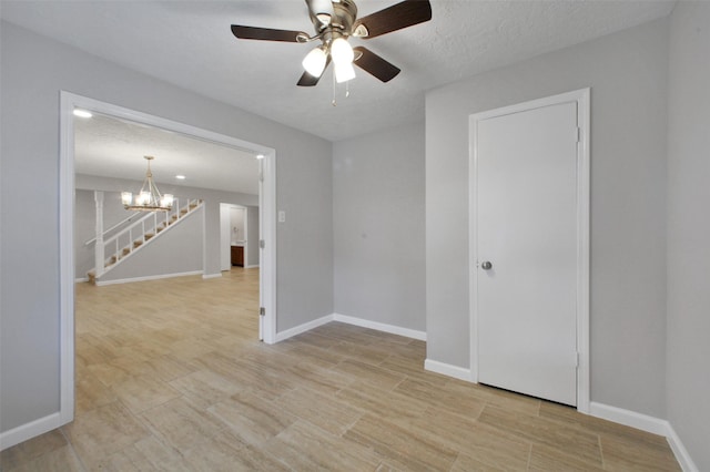 15815 Baytree Dr, Houston, TX 77070 - empty room featuring a chandelier, ceiling fan, and light wood-type flooring