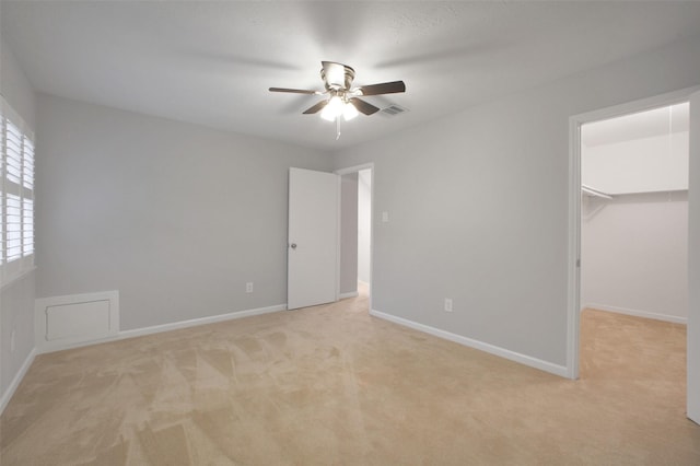 15815 Baytree Dr, Houston, TX 77070 - unfurnished bedroom featuring light colored carpet, a walk in closet, and a ceiling fan