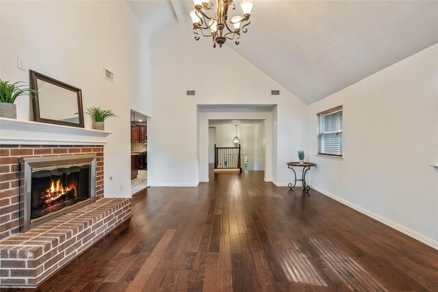 6 Sylvan Forest Dr, The Woodlands, TX 77381 - unfurnished living room featuring a chandelier, high vaulted ceiling, wood-type flooring, and a fireplace