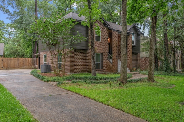6 Sylvan Forest Dr, The Woodlands, TX 77381 - view of front facade with brick siding and driveway