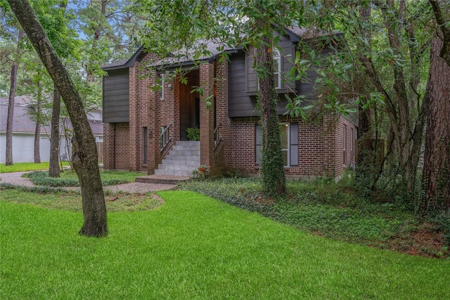 6 Sylvan Forest Dr, The Woodlands, TX 77381 - view of front of property featuring a front yard, brick siding, and a water view
