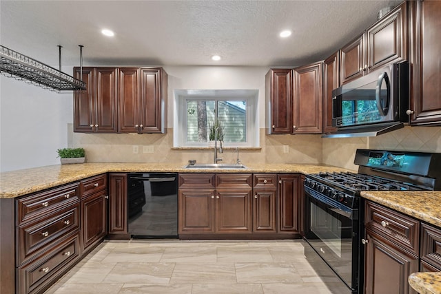 6 Sylvan Forest Dr, The Woodlands, TX 77381 - kitchen with black appliances, recessed lighting, light stone counters, tasteful backsplash, and a textured ceiling