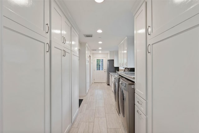 6 Sylvan Forest Dr, The Woodlands, TX 77381 - kitchen with white cabinetry, recessed lighting, light countertops, and freestanding refrigerator