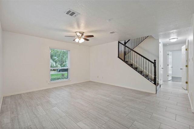 6 Sylvan Forest Dr, The Woodlands, TX 77381 - unfurnished living room with a ceiling fan, stairway, a textured ceiling, and wood finish floors