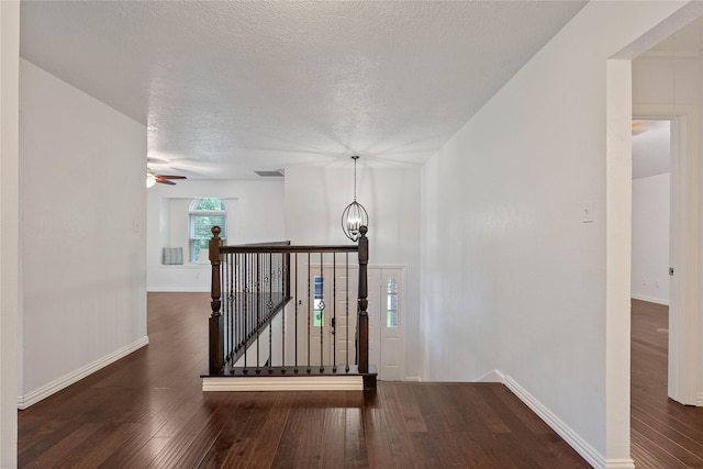 6 Sylvan Forest Dr, The Woodlands, TX 77381 - corridor featuring an upstairs landing, hardwood / wood-style flooring, a chandelier, and a textured ceiling
