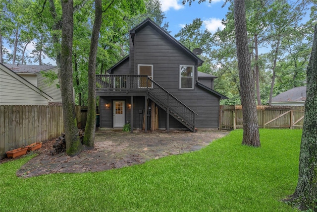 6 Sylvan Forest Dr, The Woodlands, TX 77381 - rear view of property with stairway, a fenced backyard, a wooden deck, and a patio