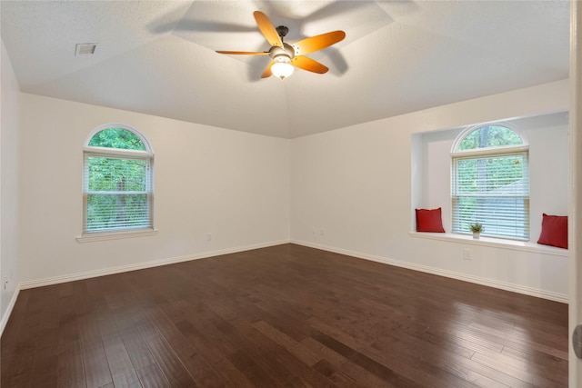 6 Sylvan Forest Dr, The Woodlands, TX 77381 - empty room with vaulted ceiling, healthy amount of natural light, dark wood-style flooring, and ceiling fan