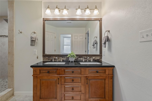 6 Sylvan Forest Dr, The Woodlands, TX 77381 - full bathroom with double vanity, backsplash, a tile shower, and tile patterned floors