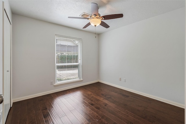 6 Sylvan Forest Dr, The Woodlands, TX 77381 - spare room featuring healthy amount of natural light, dark wood-style flooring, a ceiling fan, and a textured ceiling