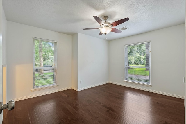6 Sylvan Forest Dr, The Woodlands, TX 77381 - spare room with plenty of natural light, dark wood-style floors, a textured ceiling, and a ceiling fan