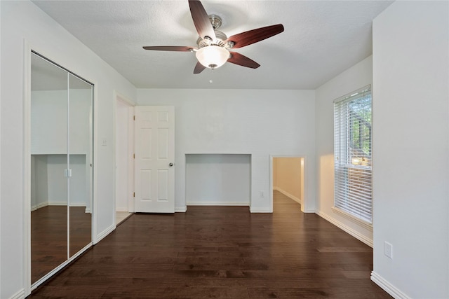 6 Sylvan Forest Dr, The Woodlands, TX 77381 - unfurnished bedroom with dark wood finished floors, a closet, a ceiling fan, and a textured ceiling