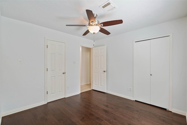 6 Sylvan Forest Dr, The Woodlands, TX 77381 - unfurnished bedroom featuring dark wood-style flooring, a closet, and ceiling fan