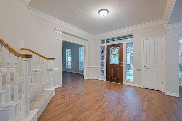 1902 Rosebay Ct, Sugar Land, TX 77479 - entrance foyer featuring ornamental molding, wood finished floors, stairway, and a textured ceiling