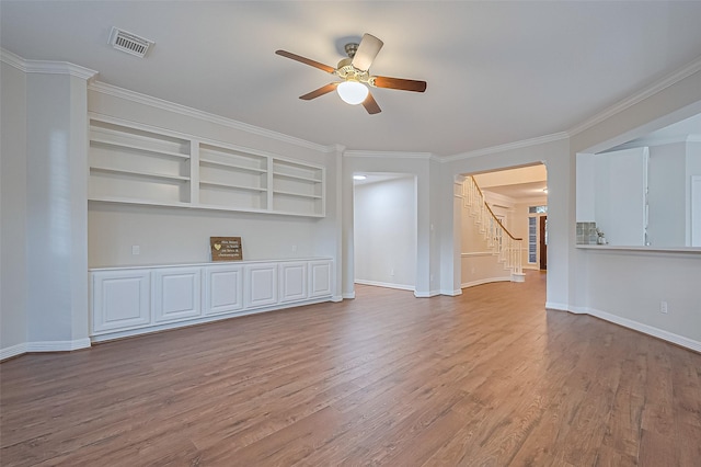 1902 Rosebay Ct, Sugar Land, TX 77479 - unfurnished living room featuring ceiling fan, wood finished floors, stairway, crown molding, and built in features