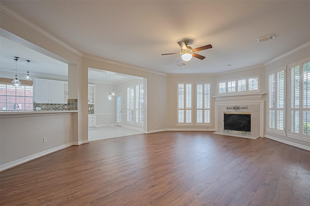 1902 Rosebay Ct, Sugar Land, TX 77479 - unfurnished living room with dark wood-style flooring, ceiling fan, a high end fireplace, and ornamental molding