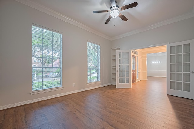 1902 Rosebay Ct, Sugar Land, TX 77479 - empty room featuring wood finished floors, crown molding, a ceiling fan, french doors, and healthy amount of natural light