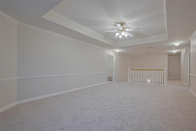 1902 Rosebay Ct, Sugar Land, TX 77479 - empty room featuring a tray ceiling, ceiling fan, ornamental molding, and light colored carpet