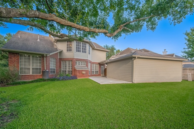 1902 Rosebay Ct, Sugar Land, TX 77479 - rear view of house featuring brick siding, a yard, and a patio