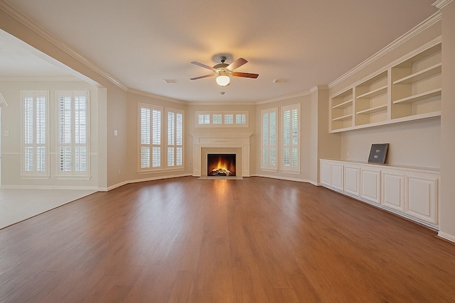 1902 Rosebay Ct, Sugar Land, TX 77479 - unfurnished living room featuring a ceiling fan, wood finished floors, a fireplace with flush hearth, ornamental molding, and built in features