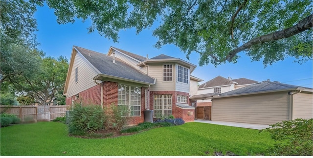 1902 Rosebay Ct, Sugar Land, TX 77479 - rear view of property with brick siding, roof with shingles, and a patio area