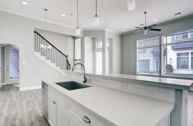 8907 Spring Knoll Forest Dr, Houston, TX 77080 - kitchen featuring stainless steel dishwasher, white cabinets, light wood-style flooring, a ceiling fan, and decorative light fixtures