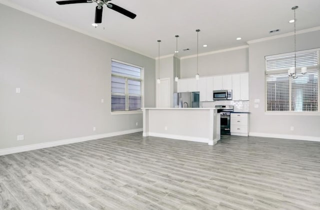 8907 Spring Knoll Forest Dr, Houston, TX 77080 - unfurnished living room with crown molding, a chandelier, ceiling fan, light wood-type flooring, and recessed lighting