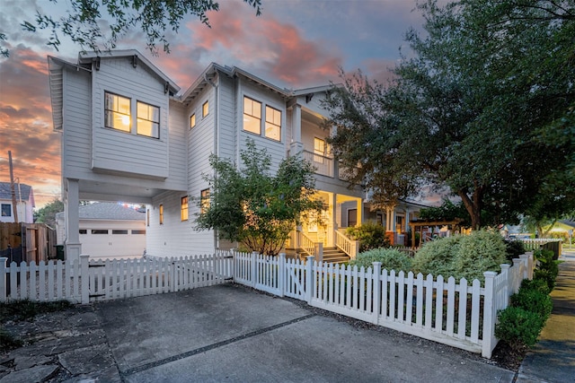 829 Ralfallen St, Houston, TX 77008 - view of front of home featuring a balcony, a fenced front yard, and concrete driveway